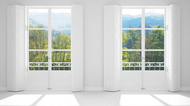 istock Stylish empty room with panoramic windows close-up, classic shutters, classic balcony. Green park, meadow with trees. White background with copy space, interior design concept 1161345140