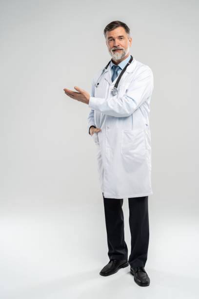doctor senior man, medical professional holding something in empty hand isolated over white background. - something imagens e fotografias de stock