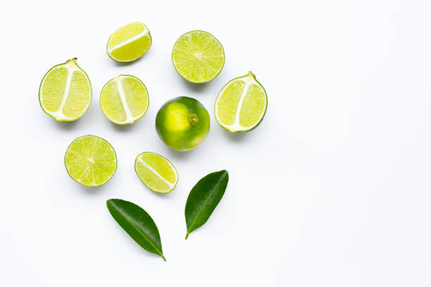 istock Fresh limes with leaves isolated on white 1161346836