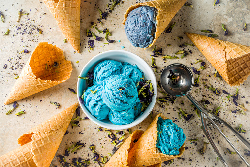 Trendy Color Changing Ice Cream with blue flowers powder, Butterfly Pea Flower Blossom gelato with ice cream waffle cones