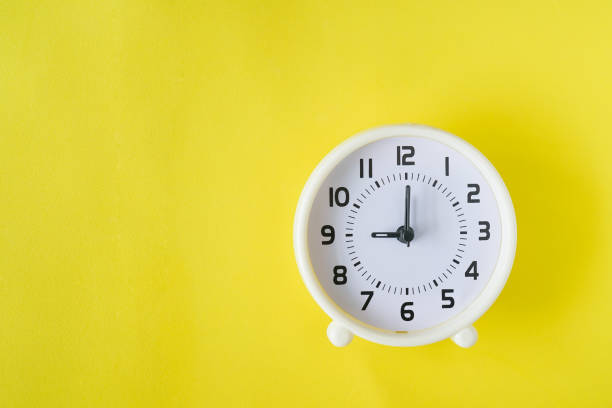 istock top view of white clock at nine o'clock on grunge yellow background 1161347850