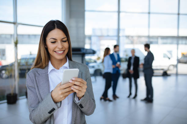 istock Young businesswoman using mobile phone and text messaging 1161348188