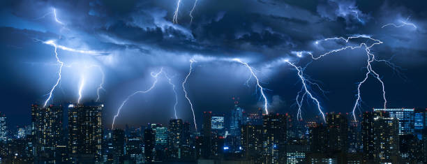 istock Lightning storm over city in blue light 1161348871