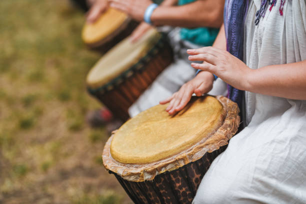 istock People playing hand drums during an outdoor workshop 1161350278