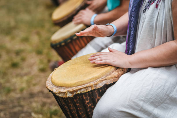 istock People playing hand drums during an outdoor workshop 1161350284