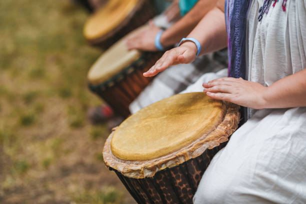 istock People playing hand drums during an outdoor workshop 1161350293