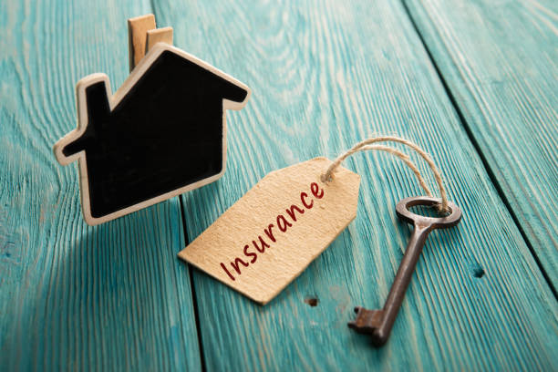 home insurance concept home insurance concept - little house and old key household insurance stock pictures, royalty-free photos & images