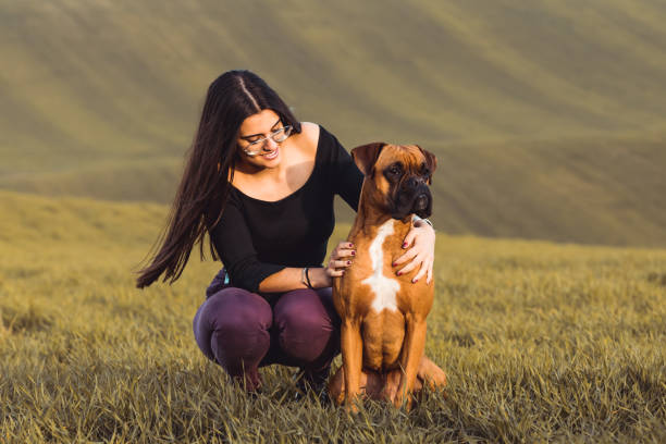 istock young woman and boxer dog in fall 1161350930