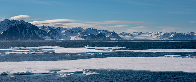 Panoramic view of ice pack with mountains on the background Svalbard Islnads