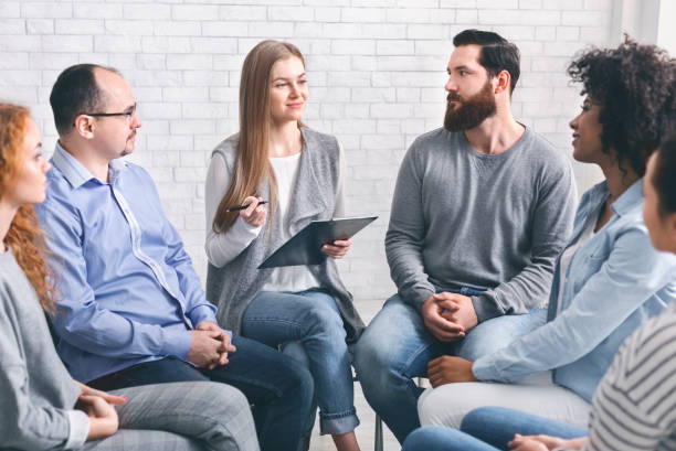 istock Psychologist talking to addicted people in office 1161351057