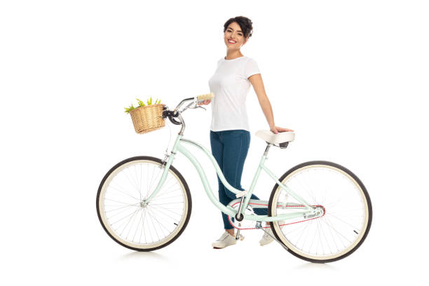 istock cheerful latin woman standing with bicycle isolated on white 1161352192