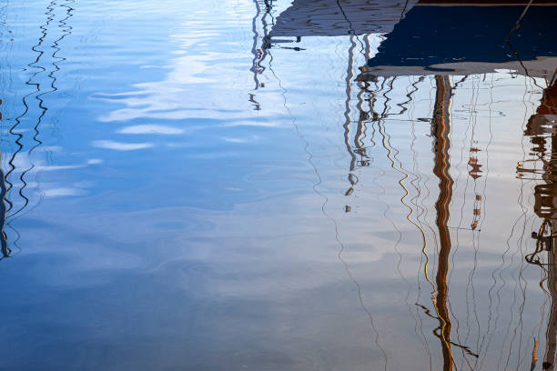 istock Yacht moored in the harbour reflecting on the water 1161353238