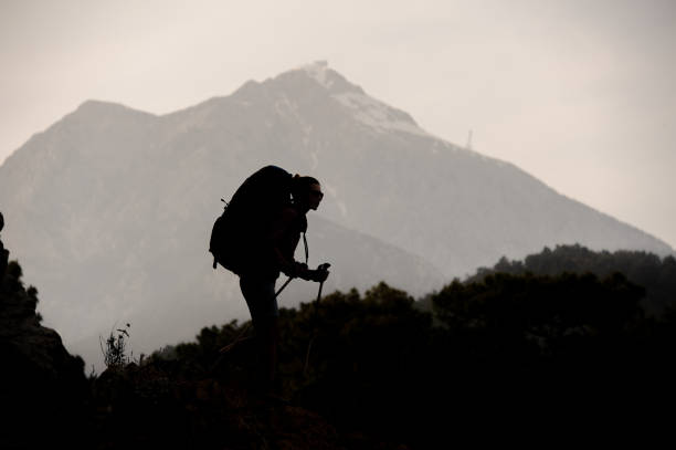 istock Silhouette of female hiker resting on mountain 1161353715
