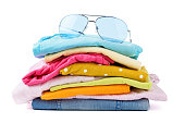 Stack of folded colorful clothes on white background.