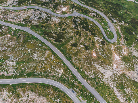 Bird's eye view of serpentine curves. Top aerial view of scenic route in Austria with name Grossglockner High Alpine Road. Some of hairpin turns of Hochtor Pass