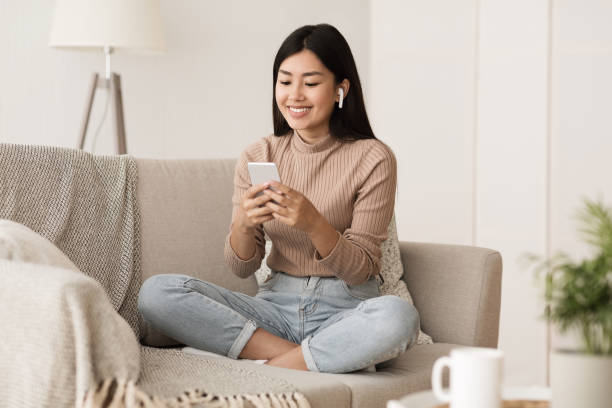 istock Student Girl Relaxing on Couch at Home with Phone 1161354384