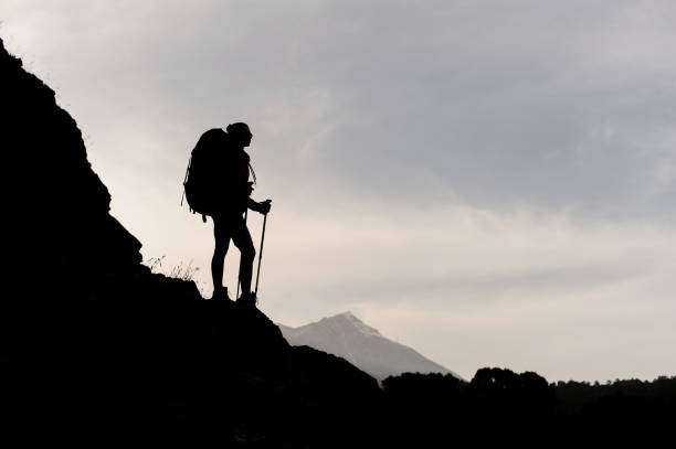 istock Silhouette of female hiker posing on mountain 1161354413