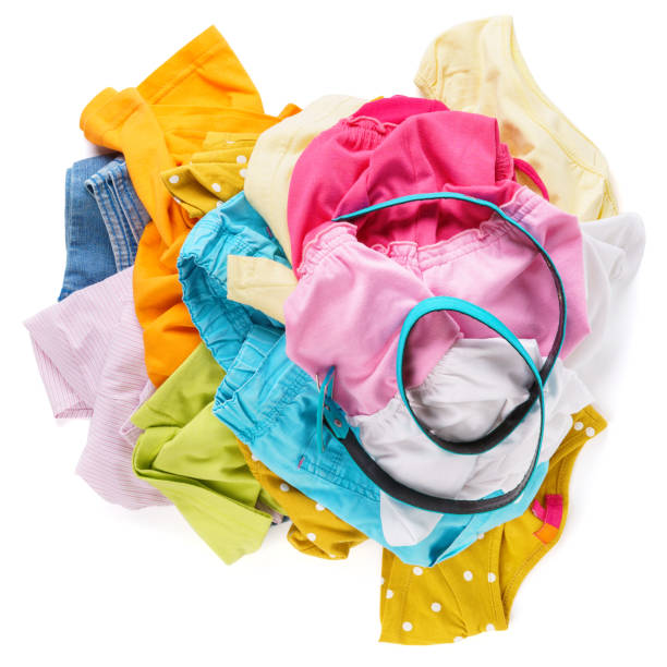 istock Messy pile of colorful summer clothes. White background. 1161354579