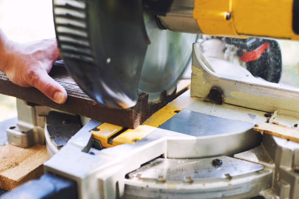 istock a man is cutting boards with a saw outdoor 1161357147