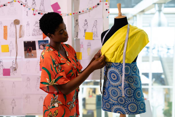 istock Female graphic designer examining clothes on mannequin in design studio 1161358335
