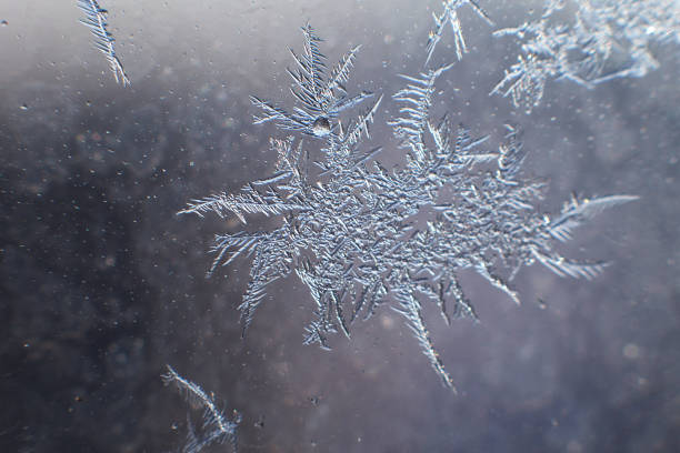istock snow pattern on the glass from frost 1161358414