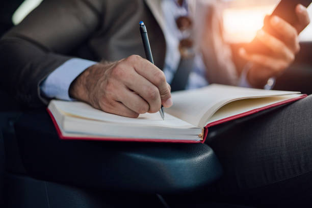 istock Business Man Writing Some Notes in the Car 1161358457