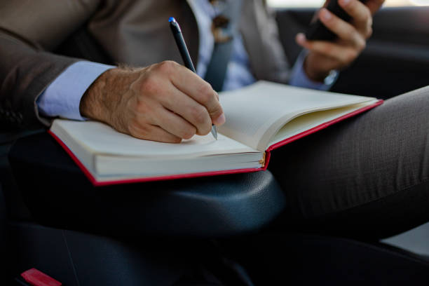 istock Business Man Writing Some Notes in the Car 1161358499