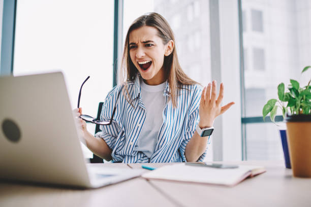 istock Angry stressed female freelancer irritated with bad internet connection sitting at desktop with netbook , irritated emotional woman raging about software failure while downloading files on laptop 1161359561
