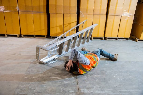 istock An industrial, warehouse, workplace safety topic.  An employee falls and injures himself falling off a ladder 1161361621