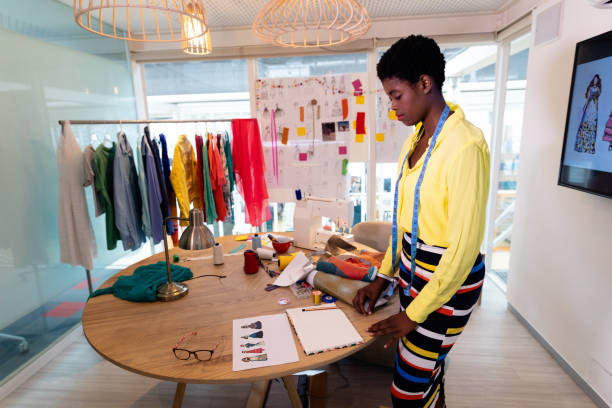 istock Female graphic designer looking at sketch in design studio 1161362313