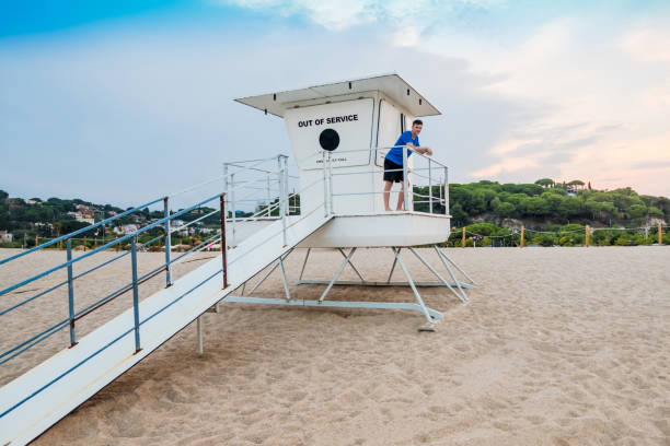 istock Cool young man on the rescue cabin at a Mediterranean beach 1161364045