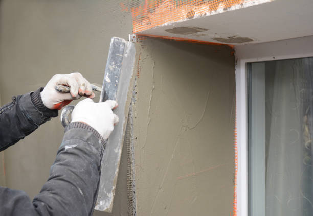 istock Building contractor plastering wall  with fiberglass mesh, stucco, plaster mesh after rigid insulation in window sill problem area. 1161364139