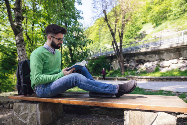 istock Student reading book in the city park 1161364297