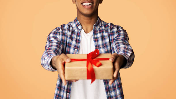 istock Cheerful Guy Offering Exclusive Gift Box to Camera 1161365191