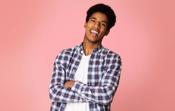 istock Excited Student Standing with Crossed Arms, Pink Background 1161365649