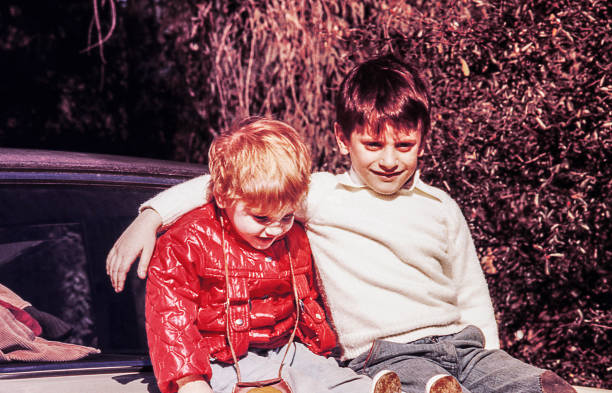 istock Blonde kid sitting on a vintage car 1161366926