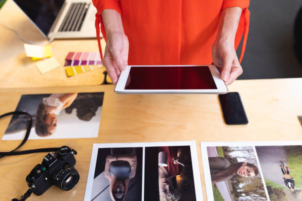 istock Female graphic designers using digital tablet at desk in office 1161368518
