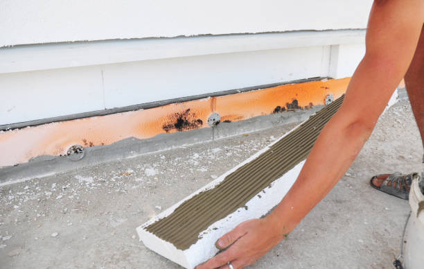 istock Contractor insulation house foundation with styrofoam insulation sheets. Wall insulation with foam board. Rigid foam insulation. 1161369855