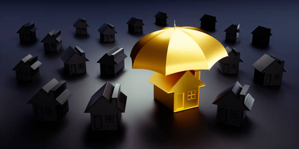 Golden toy house under an umbrella Golden toy house under an umbrella in a group of black toy houses - concept security property security stock pictures, royalty-free photos & images