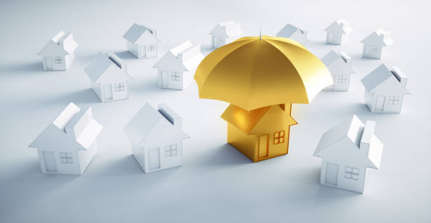 istock Golden toy house under an umbrella 1161371777