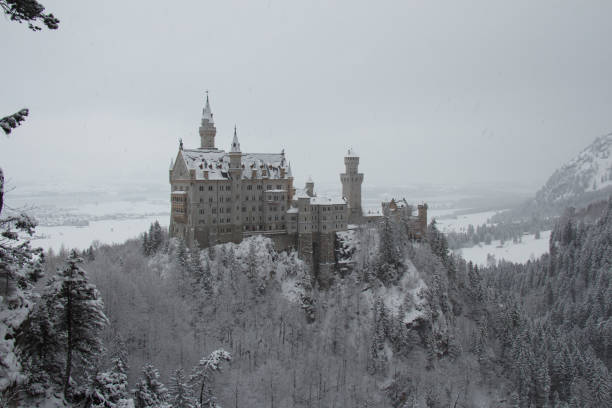 Beautiful Idylllic snowy and fogy landscape view of the Bavarian mountains, Neuschwanstein and lake in Fussen, Bavaria, Germany