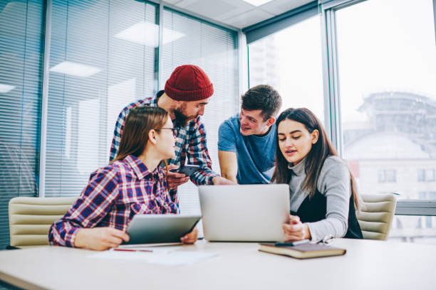 istock Group of successful male and female students searching training webinar on laptop computer, clever positive colleagues cooperating on coursework using modern technology and sharing information 1161375769