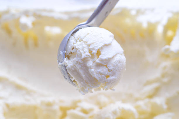 istock Ice cream scooping out of container by metal spoon close up 1161376298