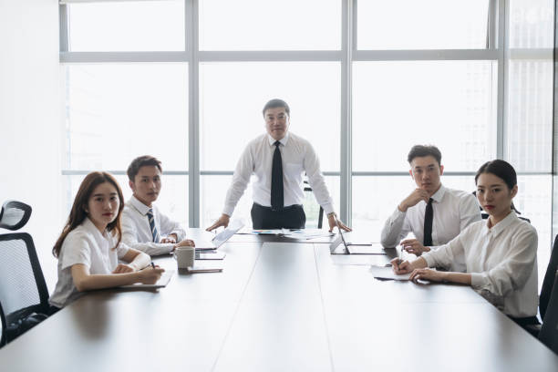 istock Mature Asian CEO and confident executive team in boardroom 1161376304
