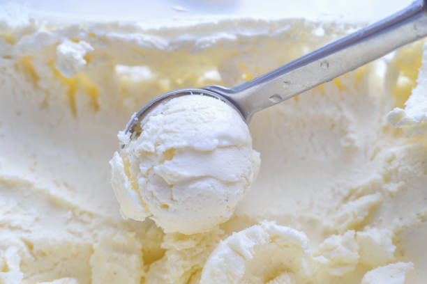 istock Ice cream scooping out of container by metal spoon close up 1161376339