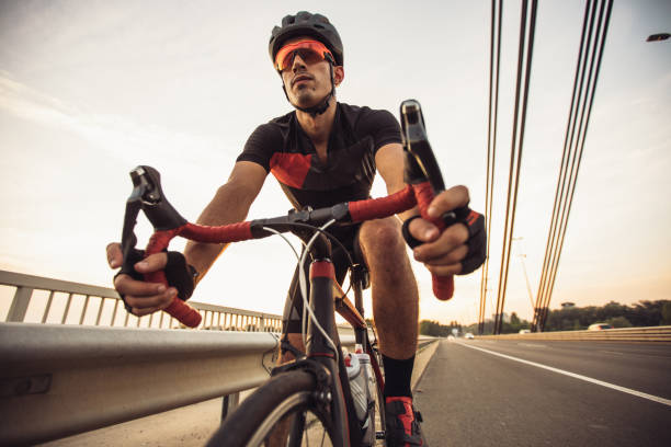 istock Man riding racing bicycle on the street 1161376400