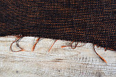 The texture of the fabric chanel large weave, on the wooden table. Brown with place for your text