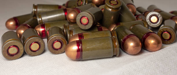 istock Cartridges bulk close up images. Bullets in shells for gun are piled randomly. Weapon armory concept 1161383894