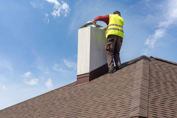 skilled workman in protective work wear and special uniform install chimney on roof top of new house under construction - chimney imagens e fotografias de stock
