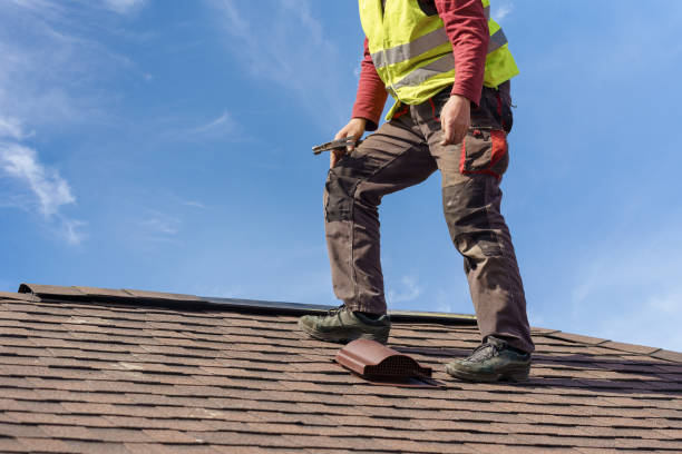 istock Unrecognizable workman standing on tile roof of new home under construction against blue sky with helmet in hands 1161384124